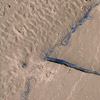 This subscene from HiRISE image PSP_003294_1895 shows a portion of the Athabasca Valles channel system.