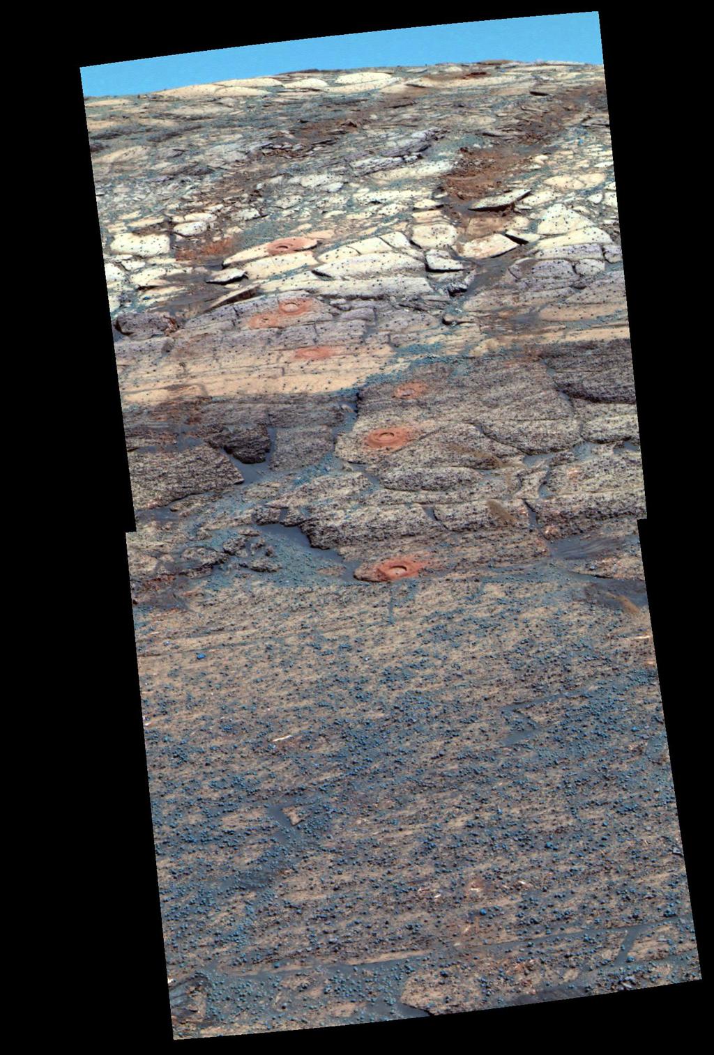 This view from the Mars Exploration Rover Opportunity's panoramic camera is a false-color composite rendering of the first seven holes that the rover's rock abrasion tool dug on the inner slope of "Endurance Crater."