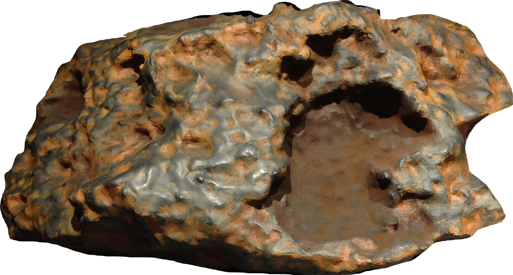 Download 3D Print File for 'Block Island' Meteorite. This is a color image of the 3D model of the Block Island meteorite, which is about the size of a microwave oven. The meteorite is oddly shaped and is a dark brown color with some touches of dark orange. The right side of the meteorite has a chunk missing and has a darker, smoother surface.