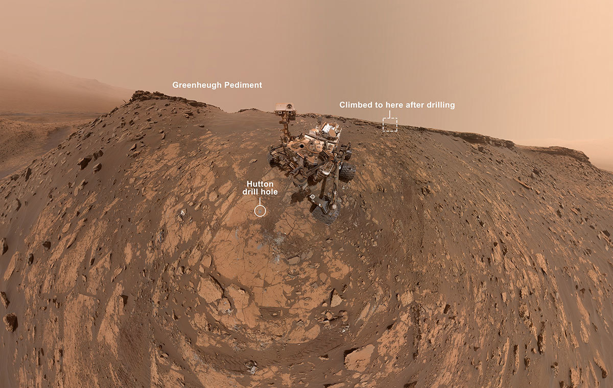 This selfie was taken by NASA's Curiosity Mars rover on Feb. 26, 2020. The crumbling rock layer at the top of the image is the Greenheugh Pediment, which Curiosity climbed soon after taking the image.
