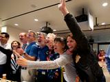 Members of the Curiosity science team jump out of their seats and cheer when they hear that the Curiosity rover has successfully landed on the Martian surface.