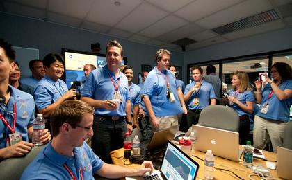 The Entry, Descent and Landing team gathers to celebrate prior to a post-landing press briefing.