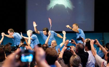 The Curiosity rover's Entry, Descent and Landing team (EDL) arrives at the post-landing press conference to cheers and celebration.