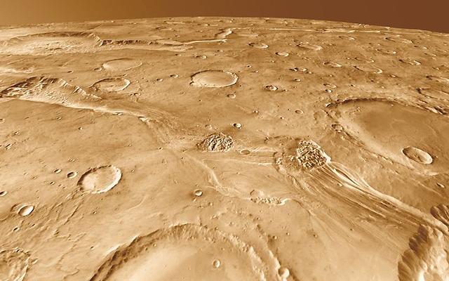 Around 200 kilometers long, Ravi Vallis was born in a flood of water from Aromatum Chaos (left). The racing waters sliced a pathway across Xanthe Terra, spawned at least two small chaos regions in the channel (center), and then hurtled over the plateau edge to disappear into another chaos region (right foreground). In the distance at left lies Orson Welles Crater and the meandering path of Shalbatana Vallis, a much longer outflow channel perhaps related hydrologically to Ravi.