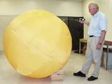 Jack A. Jones and the quarter-size version of his "Tumbleweed Ball."