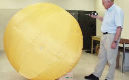 Jack A. Jones and the quarter-size version of his "Tumbleweed Ball."
