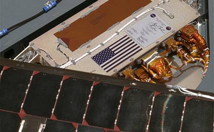This color image shows a miniature U.S. flag on a petal of the landing platform beneath NASA's Spirit rover.