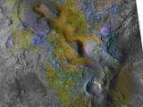 Carbonate, which is indicative of a wet and non-acidic history, occurs in very small patches of exposed rock appearing green in this color representation of an area about 20 kilometers (12 miles) wide on Mars.
