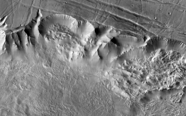 This image shows a 90-mile-wide portion of the giant Valles Marineris canyon system. Landslide debris and gullies in the canyon walls on Mars can be seen at 100 meters (330 feet) per pixel.