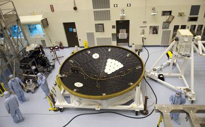 In the Payload Hazardous Servicing Facility at NASA's Kennedy Space Center in Florida, technicians process the heat shield for NASA's Mars Science Laboratory (MSL).