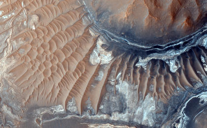 This image reveals exposed layers in Noctis Labyrinthus which may contain signatures of iron bearing sulfates and phyllosilcate (clay) minerals.
