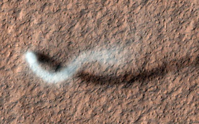 A towering dust devil casts a serpentine shadow over the Martian surface in this image acquired by the High Resolution Imaging Science Experiment (HiRISE) camera on NASA's Mars Reconnaissance Orbiter.