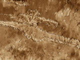 This mosaic image of Valles Marineris - colored to resemble the martian surface - comes from the Thermal Emission Imaging System (THEMIS), a visible-light and infrared-sensing camera on NASA's Mars Odyssey orbiter.