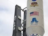 The NASA and Mars Science Laboratory (MSL) logos appear above the American flag and Atlas logo on the payload fairing atop the 197-foot-tall United Launch Alliance Atlas V rocket.