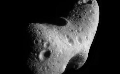An image of a potato-shaped, gray asteroid with several craters on the surface.