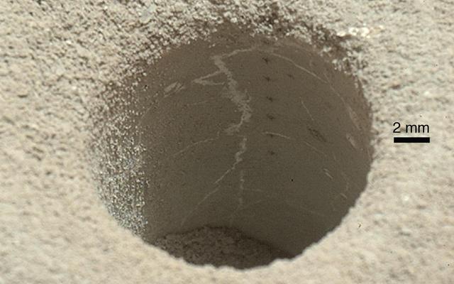 The hole that NASA's Curiosity Mars rover drilled into target rock "John Klein" provided a view into the interior of the rock, as well as obtaining a sample of powdered material from the rock.