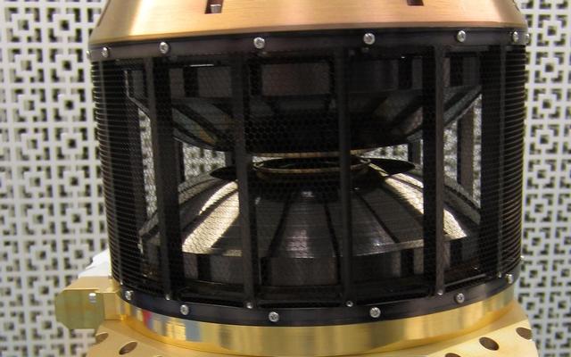 This image shows the wind analyzer instrument box that is yellow metal at the bottom, the top is a circular black cylinder.  The whole instrument is the size of a shoebox.