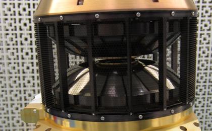 This image shows the wind analyzer instrument box that is yellow metal at the bottom, the top is a circular black cylinder.  The whole instrument is the size of a shoebox.
