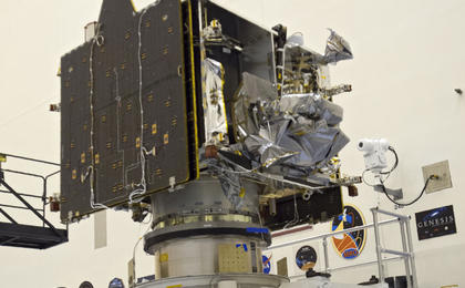 Technicians and engineers oversee MAVEN after it was attached to a processing stand.
