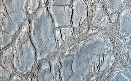 With its cracked, blistery appearance, this mound near the center of a very large, over 5-kilometer diameter mid-latitude crater poses an interesting question: how did this form?