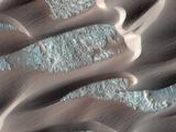 This image shows, smooth dark dunes, with lighter gray sand in between them.