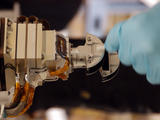 The Mars Color Imager (MARCI), shown here with a gloved hand for scale, is designed to produce a global map to help characterize daily, seasonal and year-to-year variations in Mars' climate, providing a daily weather report for Mars.