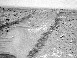 In this image from NASA's Curiosity Mars rover looking up the ramp at the northeastern end of "Hidden Valley," a pale outcrop including drilling target "Bonanza King" is at the center of the scene.