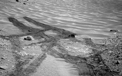 This image from NASA's Curiosity Mars rover looks down the ramp at the northeastern end of "Hidden Valley" and across the sandy-floored valley to lower slopes of Mount Sharp on the horizon.