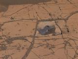 This image shows the first holes drilled by NASA's Mars rover Curiosity at Mount Sharp. The loose material near the drill holes is drill tailings and an accumulation of dust that slid down the rock during drilling.
