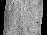 This THEMIS visible image shows a close-up view of the ridged plains in Hesperia Planum. This region is the classic locality for martian surfaces that formed in the "middle ages" of martian history. The absolute age of these surfaces is not well known. However, using the abundance of impact craters, it is possible to determine that the Hesperian plains are younger than the ancient cratered terrains that dominate the southern hemisphere, and are older than low-lying plains of the northern hemisphere. In this image it is possible to see that this surface has a large number of 1-3 km diameter craters, indicating that this region is indeed very old and has subjected to a long period of bombardment. A large (80 km diameter) crater occurs just to the north (above) this image. The material that was thrown out onto the surface when the crater was formed ("crater ejecta") can be seen at the top of the THEMIS image. This ejecta material has been heavily eroded and modified since its formation, but there are hints of lobate flow features within the ejecta. Lobate ejecta deposits are thought to indicate that ice was present beneath the surface when the crater was formed, leading to these unusual lobate features. Many of the Hesperian plains are characterized by ridged surfaces. These ridges can be easily seen in the MOLA context image, and several can be seen cutting across the lower portion of the THEMIS image. These "wrinkle" ridges are thought to be the result of compression (squeezing) of the lavas that form these plains.