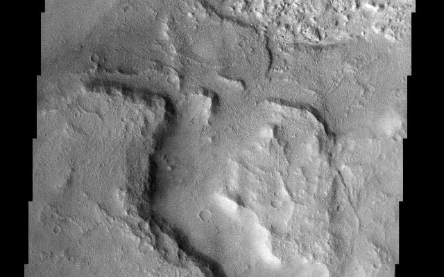 The floor of this crater in Terra Sirenum contains layered material. The layered sedimentary material on Mars is arguably the most interesting and compelling material on the planet. These layers most likely contain the answers to fundamental questions about Martian geology, climate, and possibly even biology.