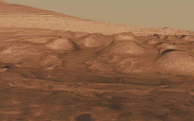 This oblique view of the lower mound in Gale crater shows layers of rock that preserve a record of environments on Mars.