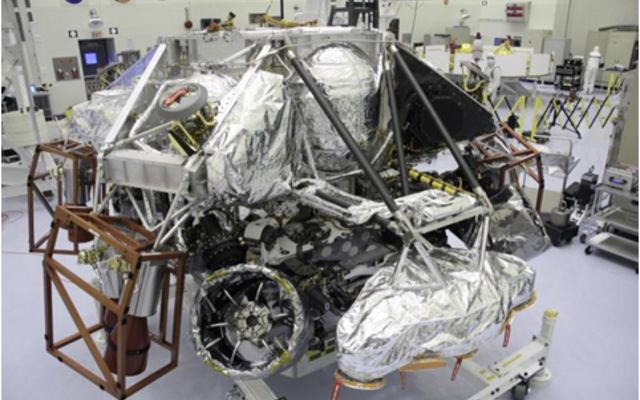 The Mars Science Laboratory mission's "powered descent vehicle" is the integrated combination of the spacecraft's descent stage and the rover Curiosity. It is shown inside the Payload Hazardous Servicing Facility at NASA Kennedy Space Center, Fla. in this photograph taken during final assembly of the spacecraft.