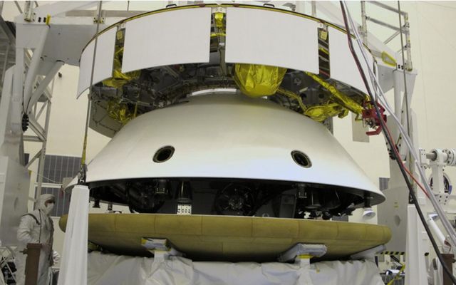 During final stacking of NASA's Mars Science Laboratory spacecraft, the heat shield is positioned for integration with the rest of the spacecraft in this photograph from inside the Payload Hazardous Servicing Facility at NASA Kennedy Space Center, Fla.