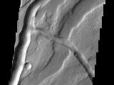 The channels in this VIS image are part of Tyrrhena Fossae on the northern flank of Tyrrhenus Mons.