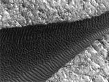 Back-and-forth blinking of this two-image animation shows movement of ripples covering a sand dune on Mars.