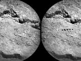 The Chemistry and Camera (ChemCam) instrument on NASA's Mars rover Curiosity used its laser to examine side-by-side points in a target patch of soil, leaving the marks apparent in this before-and-after comparison.