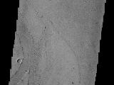 Marte Vallis, located in Amazonis Planitia, is broad and shallow. The streamlined islands at the top and bottom of the image illustrate this.