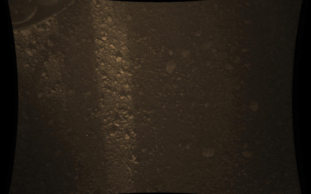 This full-resolution color image from NASA's Curiosity Rover shows the gravel-covered surface of Mars. It was taken by the Mars Descent Imager (MARDI) several minutes after Curiosity touched down on Mars.
