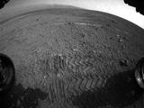 This image taken by a front Hazard-Avoidance camera on NASA's Curiosity shows track marks from the rover's first Martian drives. The rover's Bradbury Landing site and its first tire marks are seen at center, in the distance, while tracks from the second drive are in the foreground. Mount Sharp is on the horizon, which is curved to due to the camera's fisheye lens.