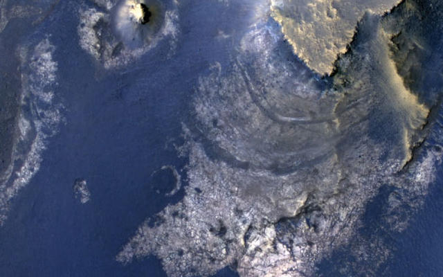 This view of layered rocks on the floor of McLaughlin Crater shows sedimentary rocks that contain spectroscopic evidence for minerals formed through interaction with water.