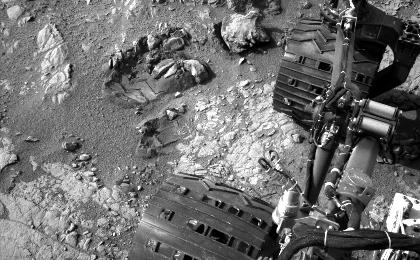 This view of Curiosity's left-front and left-center wheels and of marks made by wheels on the ground in the "Yellowknife Bay" area comes from one of six cameras used on Mars for the first time more than six months after the rover landed.
