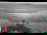 This stereo view from the navigation camera on NASA's Mars Exploration Rover Opportunity shows a vista across Endeavour Crater, with the rover's own shadow in the foreground.