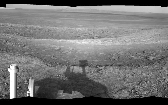 This left-eye member of a stereo pair of images from the navigation camera on NASA's Mars Exploration Rover Opportunity shows a vista across Endeavour Crater, with the rover's own shadow in the foreground.