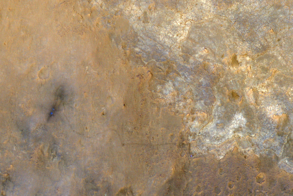 NASA's Mars Science Laboratory rover Curiosity appears as a bluish dot near the lower right corner of this enhanced-color view from the High Resolution Imaging Science Experiment (HiRISE) camera on NASA's Mars Reconnaissance Orbiter.