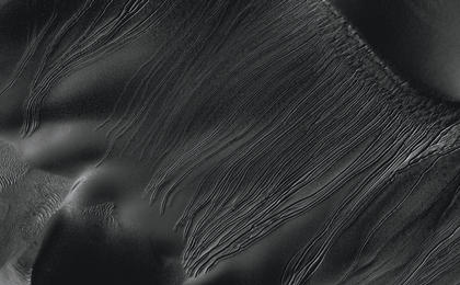 Several types of downhill flow features have been observed on Mars. This image from the High Resolution Imaging Science Experiment (HiRISE) camera on NASA's Mars Reconnaissance Orbiter is an example of a type called "linear gullies."