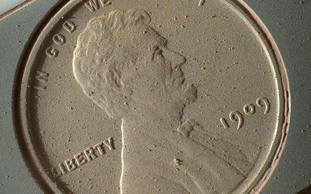 This image of a U.S. penny on a calibration target was taken by the Mars Hand Lens Imager (MAHLI) aboard NASA's Curiosity rover in Gale Crater on Mars. At 14 micrometers per pixel, this is the highest-resolution image that MAHLI can acquire.