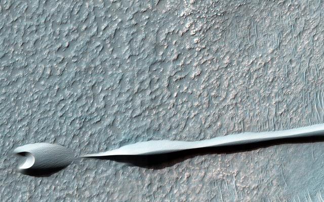 Sand dunes such as those seen in this image have been observed to creep slowly across the surface of Mars through the action of the wind.