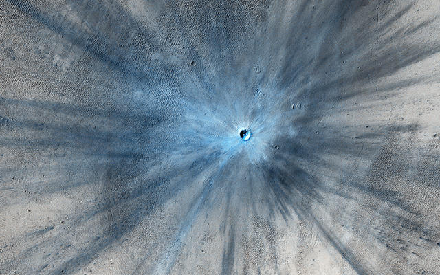 A dramatic, fresh impact crater dominates this image taken by the High Resolution Imaging Science Experiment (HiRISE) camera on NASA's Mars Reconnaissance Orbiter on Nov. 19, 2013.