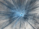 A dramatic, fresh impact crater dominates this image taken by the High Resolution Imaging Science Experiment (HiRISE) camera on NASA's Mars Reconnaissance Orbiter on Nov. 19, 2013.